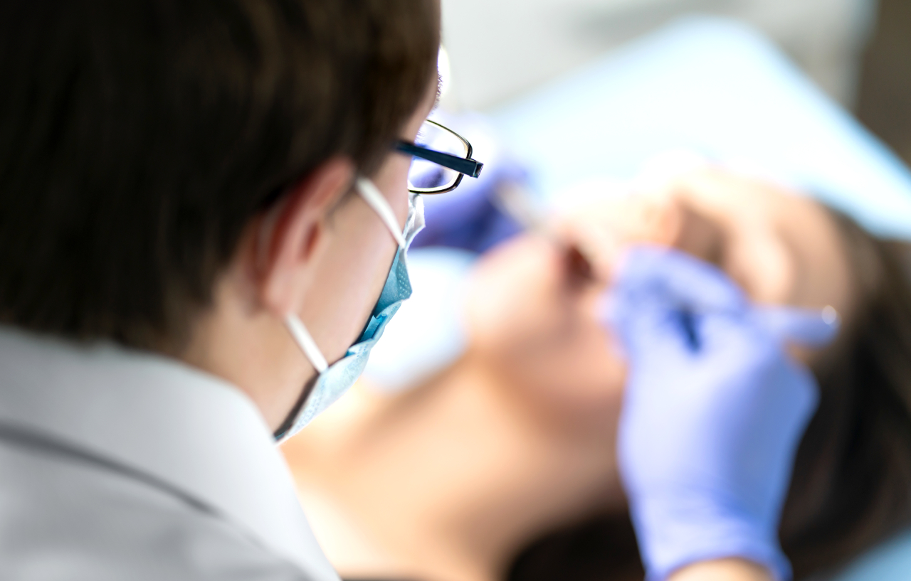Oral surgeon performing a wisdom teeth removal procedure
