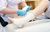 Nurse bandages a patients ankle