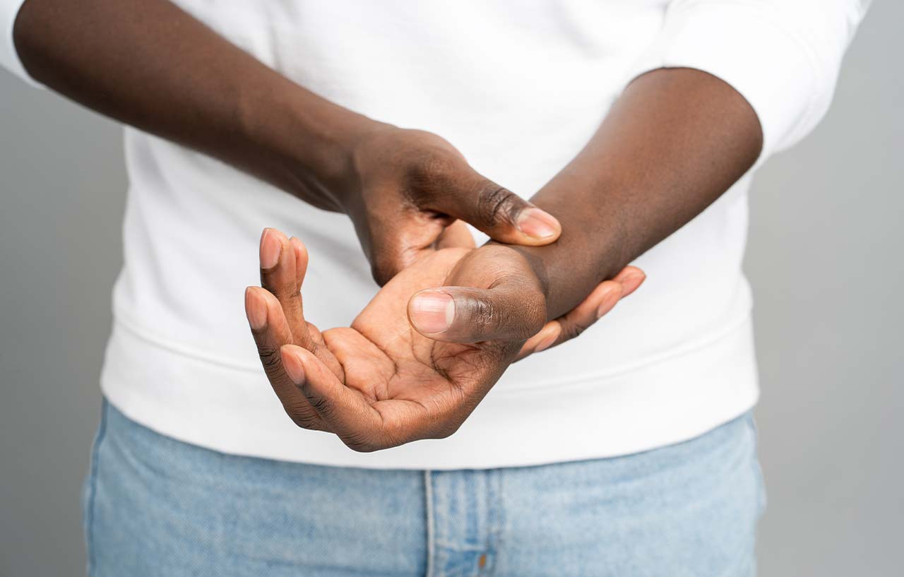 Man suffering from wrist and hand pain holding onto his wrist