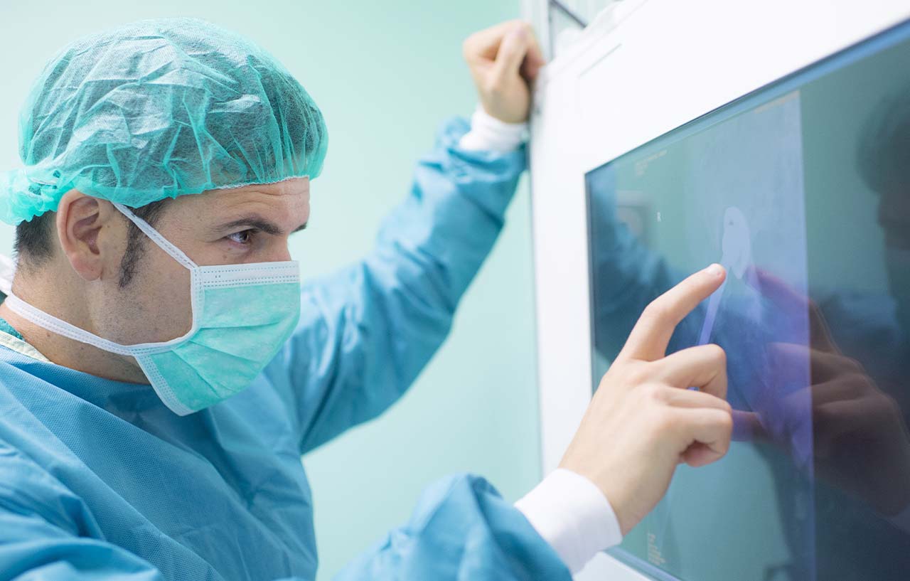Surgeon looking at xrays before peforming surgery
