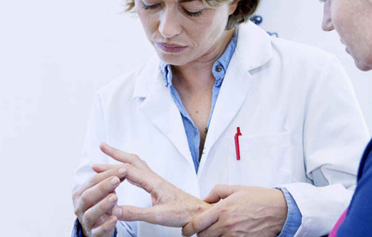 Hand specialist assessing a patient's need for trigger finger treatment