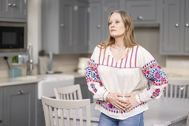 Woman holding her pelvis in pain needs pelvic health physiotherapy sessions