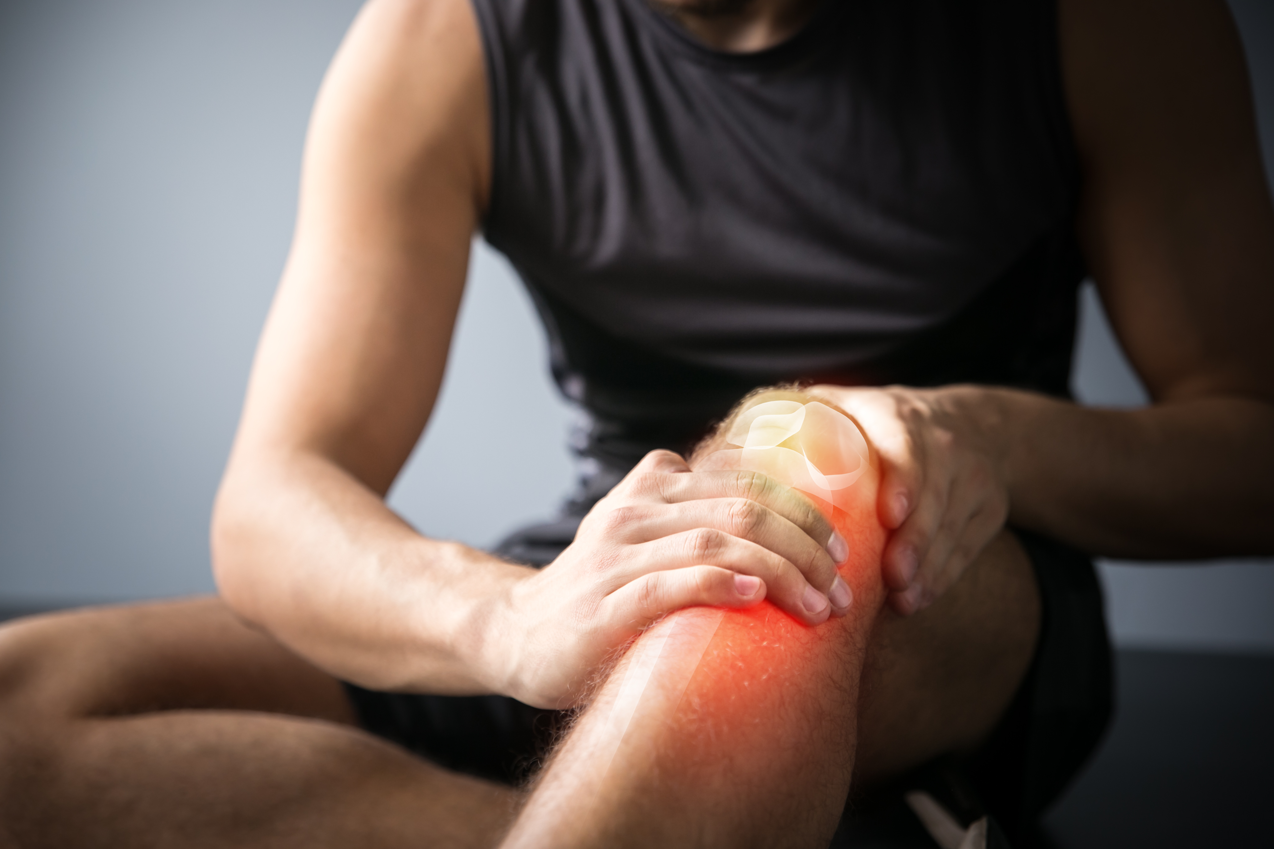 A man holding his injured leg