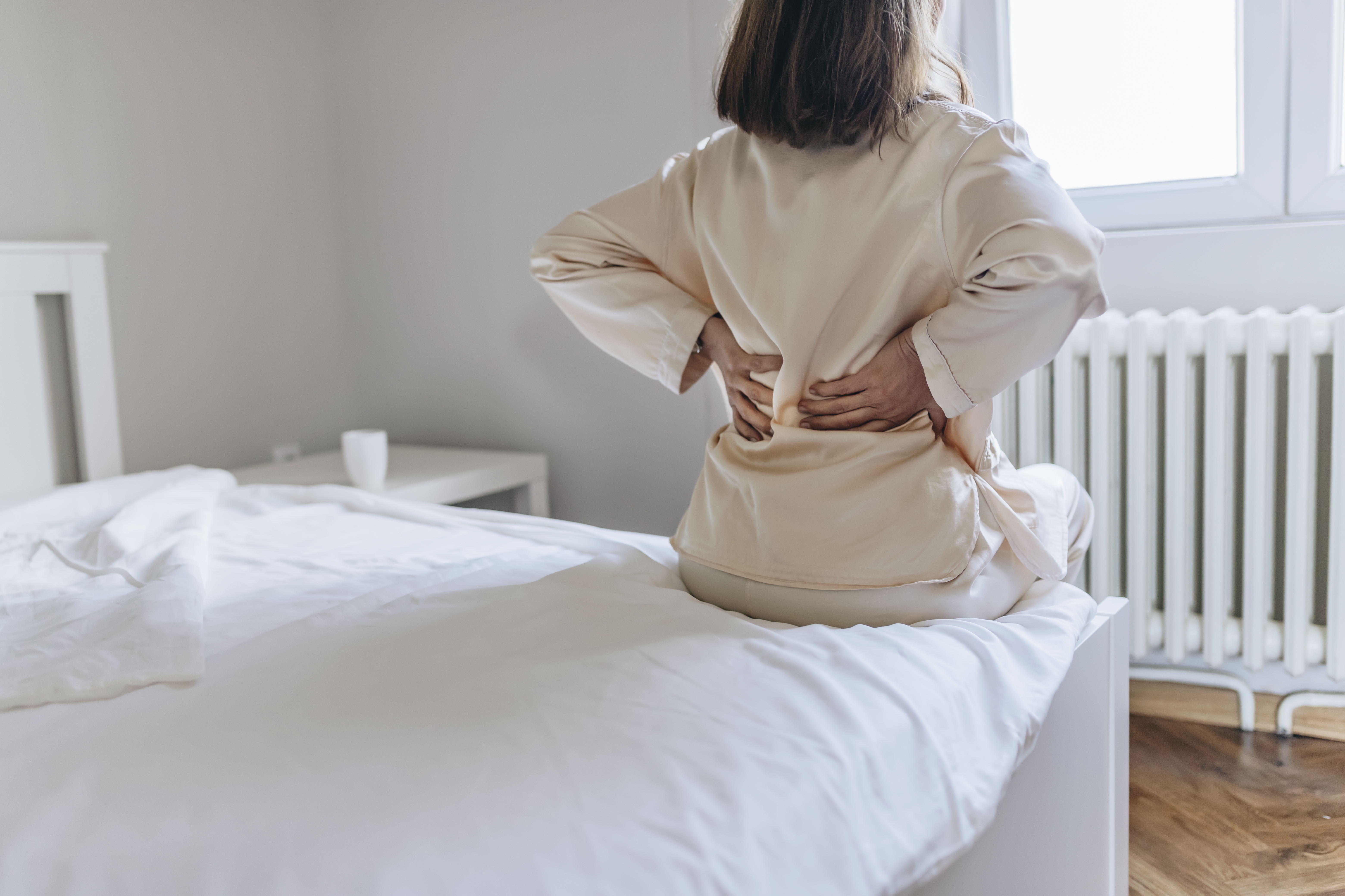Woman feels back pain 