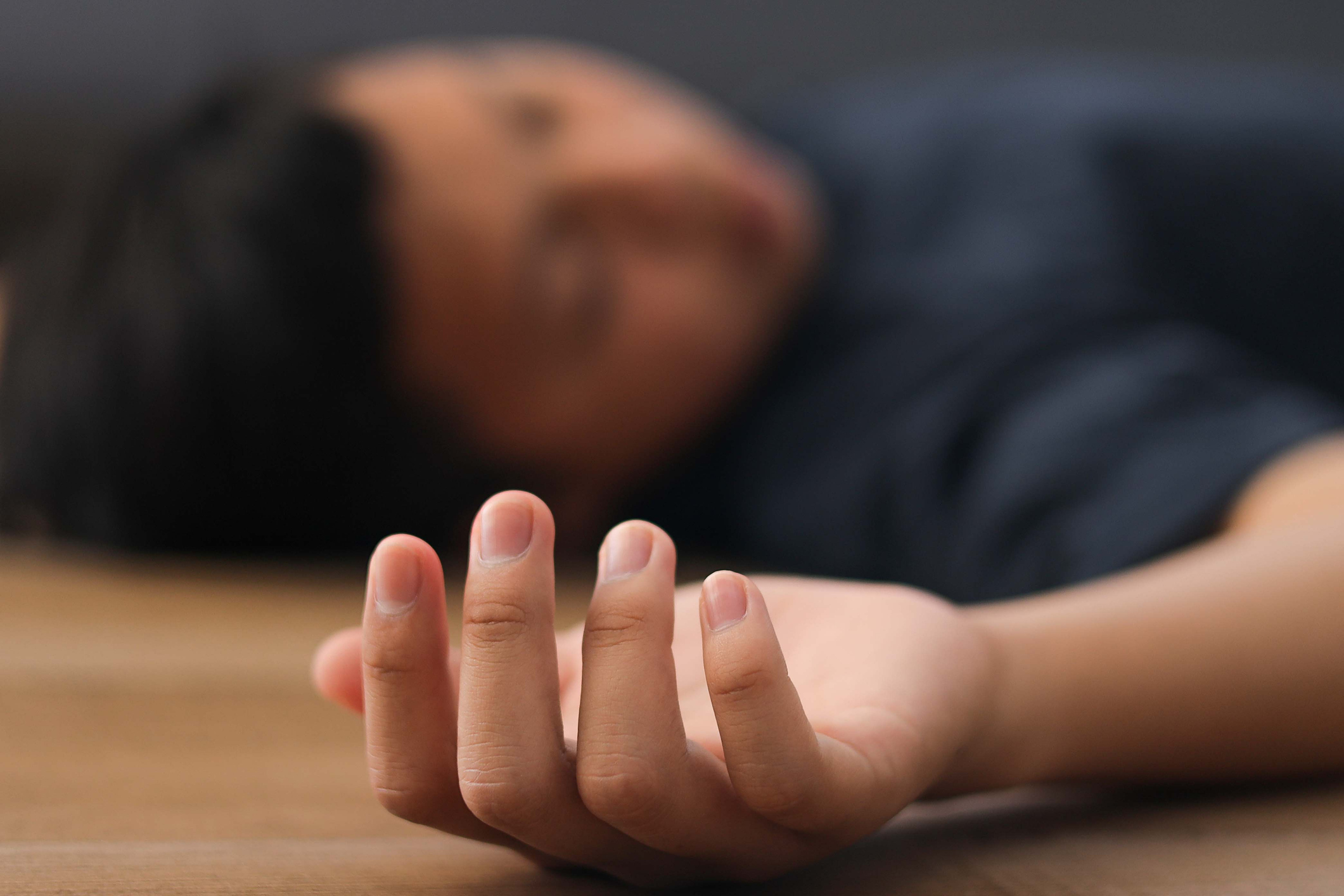 A woman is lying on the floor unconscious 