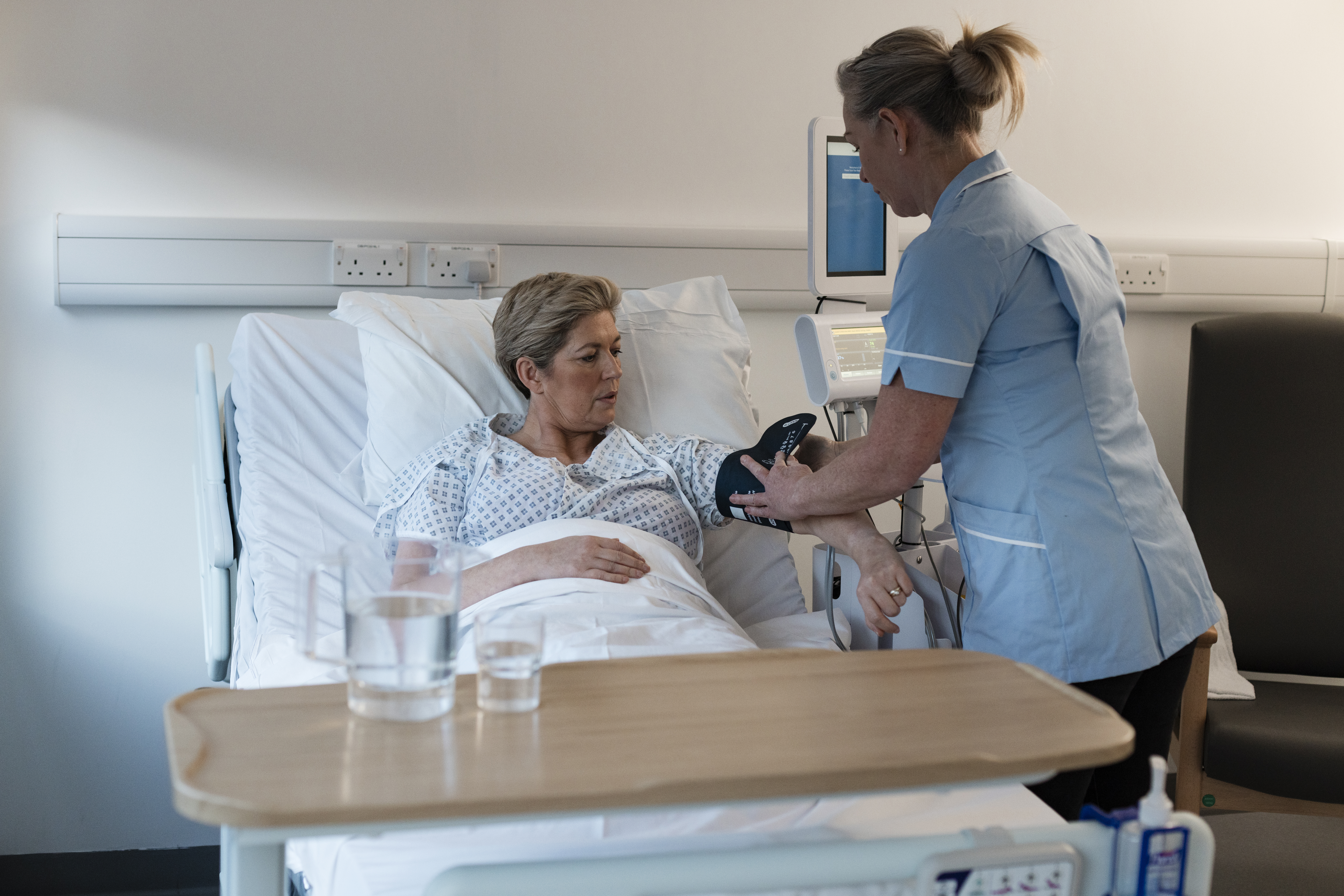 An elderly woman being cared for by a nurse