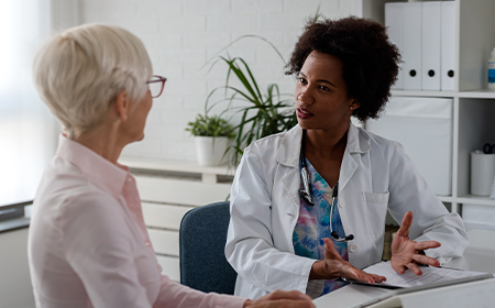 female clinician speaking to patient in consultation