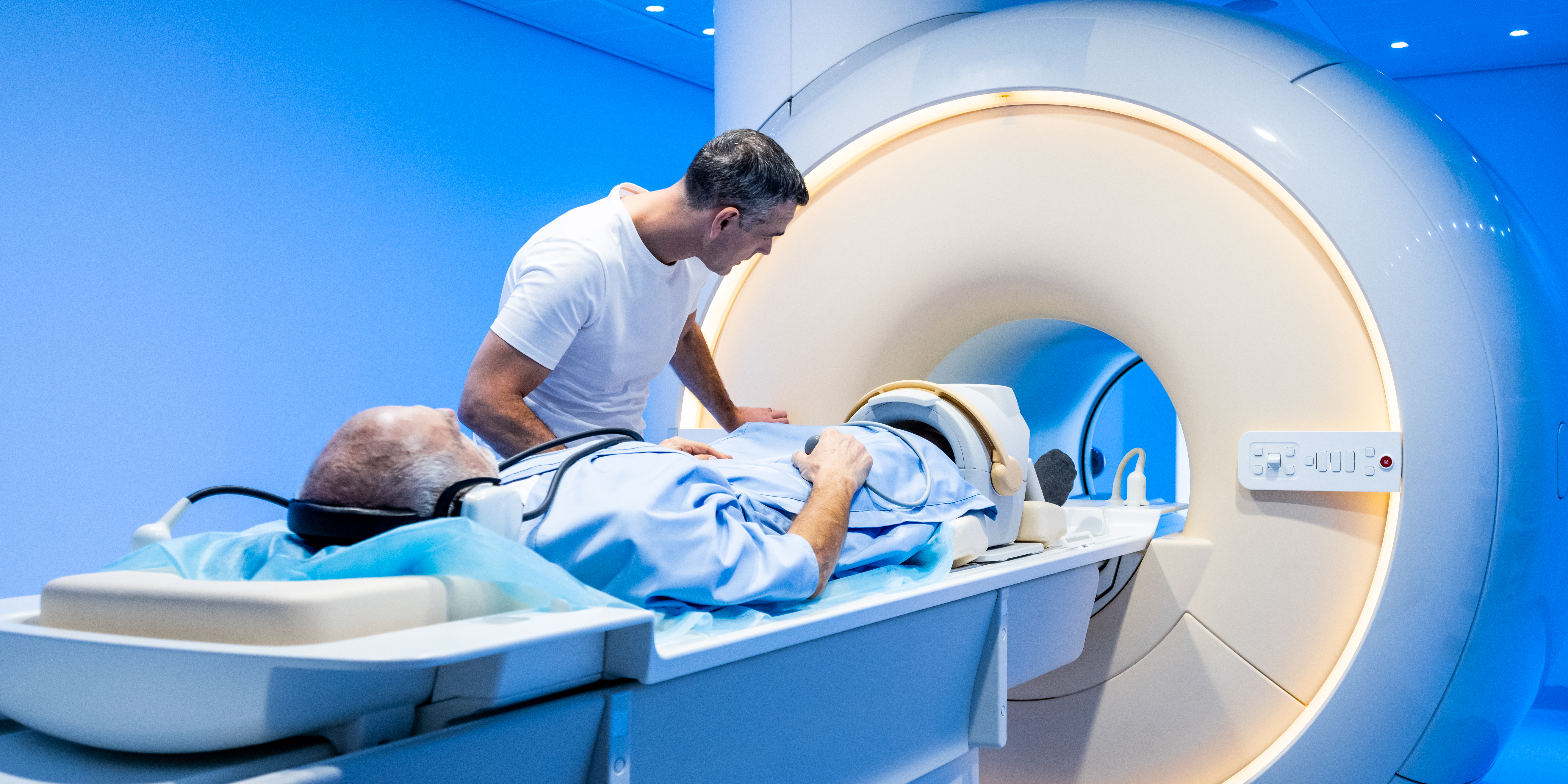 Doctor preparing patient for scanning in MRI tunnel