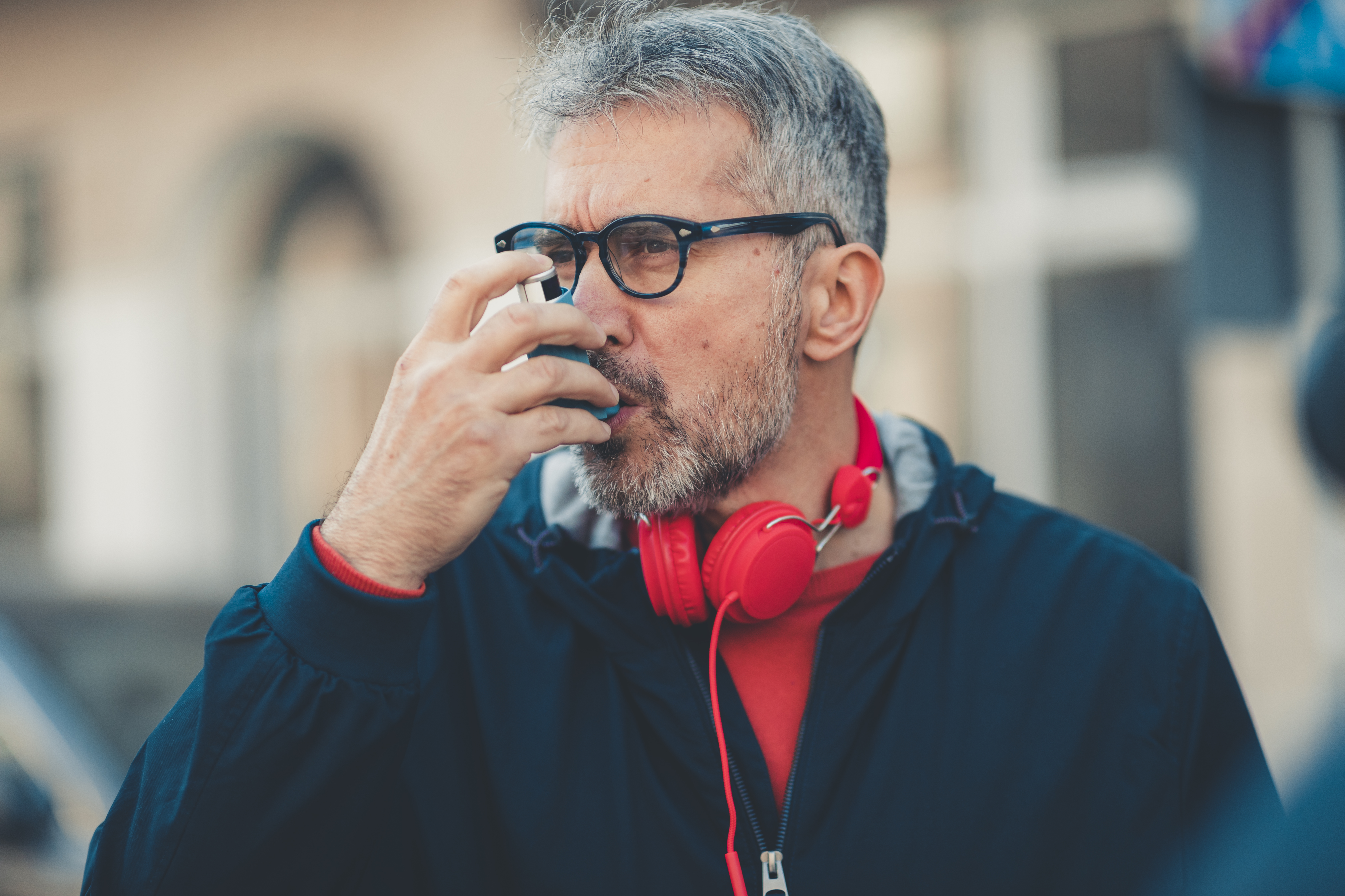 Man using an asthma inhaler