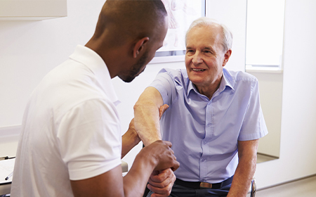 specialist performing physical examination of patients elbow and shoulder joints
