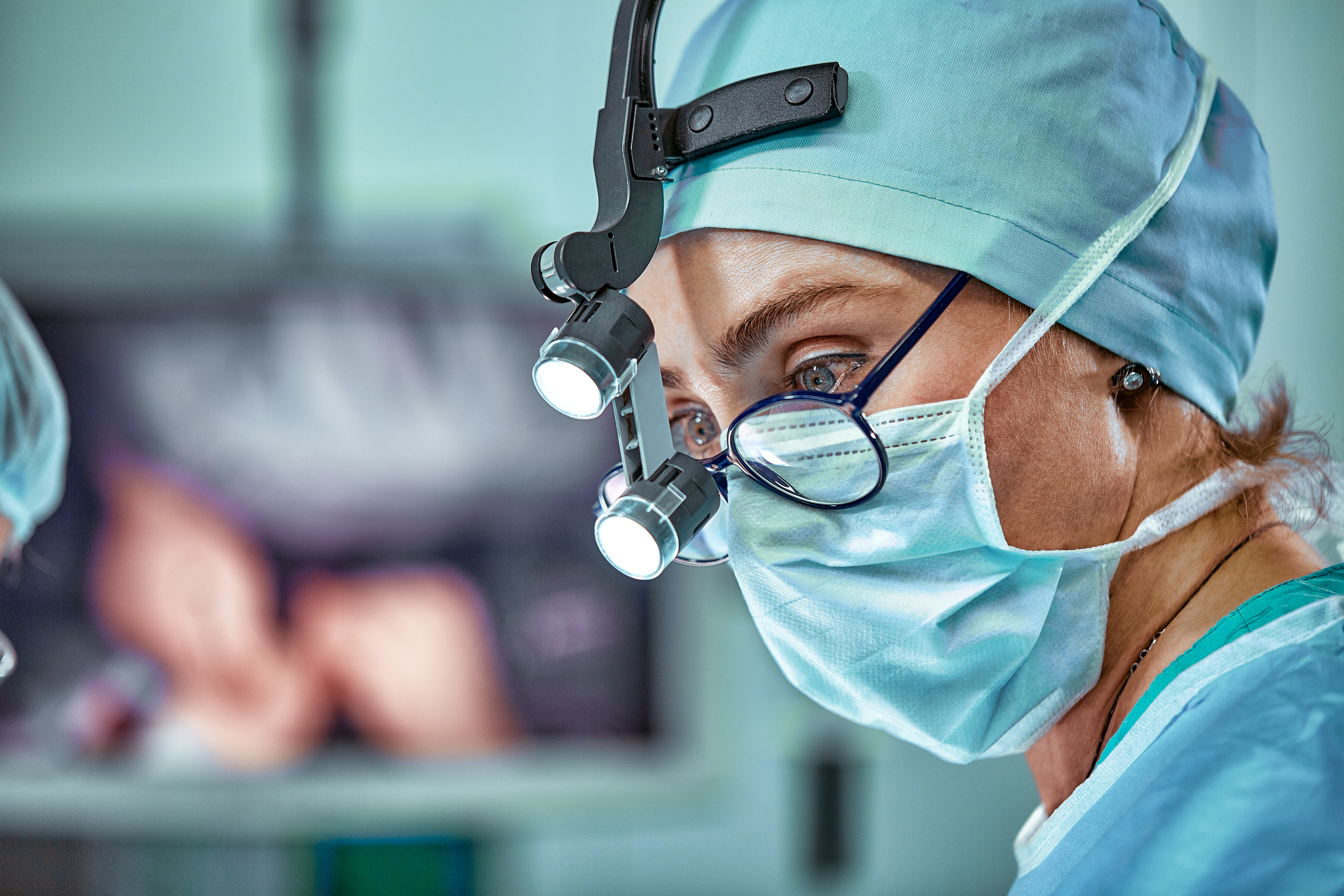 Female surgeon in operation room with reflection in glasses