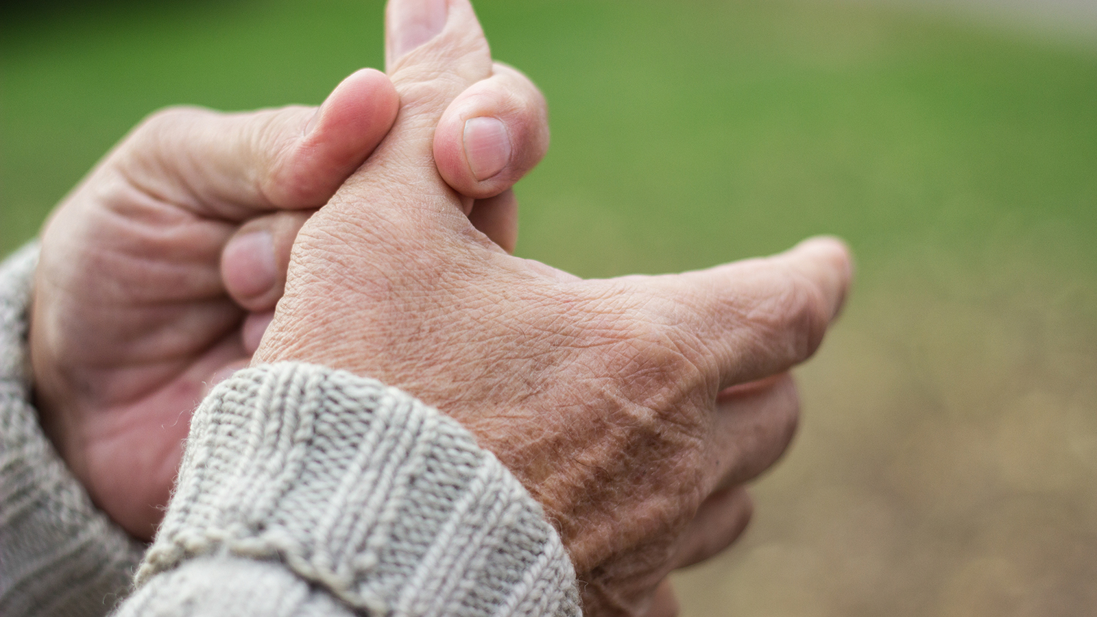 close up of hands with thumb arthritis pain