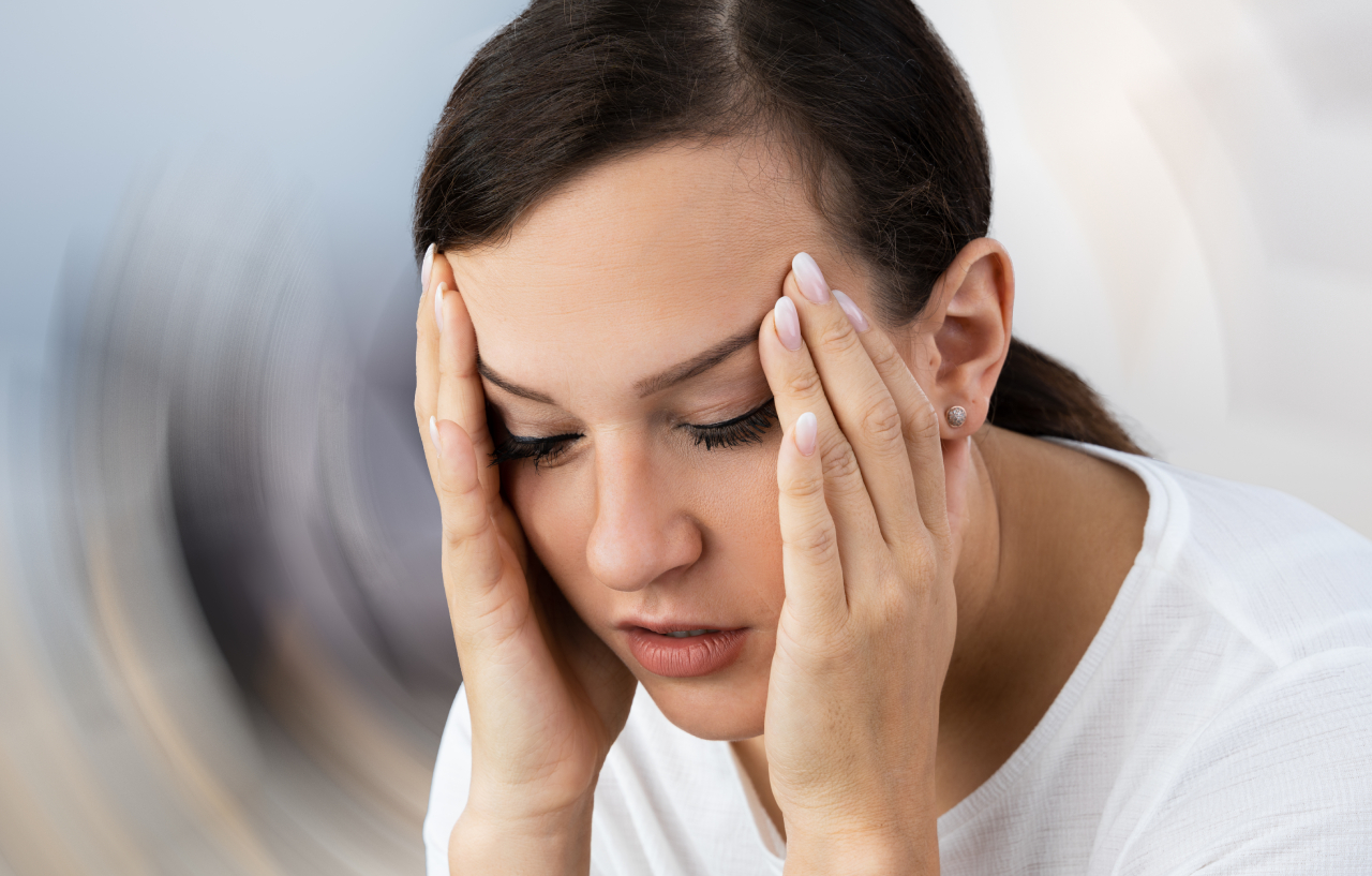 Woman who needs vestibular rehabilitation physiotherapy feels dizzy and nauseous
